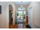 Welcoming foyer features hardwood floors, an arched doorway, and a view of the screened porch at 2019 Gardenia Landings Lane Ln, Sun City Center, FL 33573