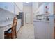 This updated kitchen features white cabinets and appliances, countertops and flows into the dining and living areas at 2019 Gardenia Landings Lane Ln, Sun City Center, FL 33573
