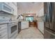 Updated kitchen features white cabinets, modern appliances, and an open floor plan leading to the dining area at 2019 Gardenia Landings Lane Ln, Sun City Center, FL 33573