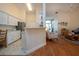 Kitchen offers white cabinets and countertops and flows into the living area for seamless entertaining at 2019 Gardenia Landings Lane Ln, Sun City Center, FL 33573