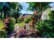 Picturesque landscaped yard showcasing vibrant plants, trees and rock pathway at 2019 Gardenia Landings Lane Ln, Sun City Center, FL 33573