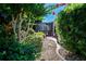 Well-maintained landscape features rock pathway and screened patio at 2019 Gardenia Landings Lane Ln, Sun City Center, FL 33573