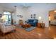Spacious living room features hardwood floors, high ceilings, and a view of the foyer at 2019 Gardenia Landings Lane Ln, Sun City Center, FL 33573