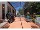 Enclosed patio with outdoor furniture and a grill, ideal for relaxation and outdoor dining at 2019 Gardenia Landings Lane Ln, Sun City Center, FL 33573
