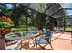 Enclosed patio with dining area, perfect for outdoor meals and enjoying the surrounding nature at 2019 Gardenia Landings Lane Ln, Sun City Center, FL 33573