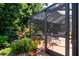 View of the screened patio with ample seating and a beautiful garden view at 2019 Gardenia Landings Lane Ln, Sun City Center, FL 33573