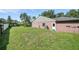 Large fenced backyard with mature trees and lawn, providing privacy and ample space for outdoor activities at 22422 Stillwood Dr, Land O Lakes, FL 34639