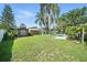 Large fenced backyard with well-maintained lawn, storage sheds, and access to the swimming pool at 22422 Stillwood Dr, Land O Lakes, FL 34639