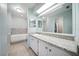 Bright bathroom with granite counters, tile floor, large mirror, and access to walk-in closet at 22422 Stillwood Dr, Land O Lakes, FL 34639