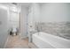 Clean bathroom with updated tile, a soaking tub, and modern fixtures at 22422 Stillwood Dr, Land O Lakes, FL 34639