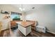 Bright dining space featuring wood flooring, a cozy built-in bench, and a modern light fixture at 22422 Stillwood Dr, Land O Lakes, FL 34639