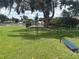 Community park with outdoor fitness equipment, grassy field, and lakeside views at 22422 Stillwood Dr, Land O Lakes, FL 34639