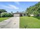 Charming single-story home with well-maintained lawn, mature trees, and a two-car garage at 22422 Stillwood Dr, Land O Lakes, FL 34639