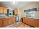 Functional kitchen with stainless steel appliances, wood cabinets, and granite countertops at 22422 Stillwood Dr, Land O Lakes, FL 34639