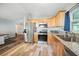 Bright kitchen with stainless steel appliances, wood cabinets, and open access to living area at 22422 Stillwood Dr, Land O Lakes, FL 34639