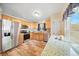 Well-lit kitchen boasting stainless steel appliances, wooden cabinets, and ample counter space at 22422 Stillwood Dr, Land O Lakes, FL 34639