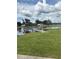 Picturesque lake view with a grassy shore and fishing pier at the community park at 22422 Stillwood Dr, Land O Lakes, FL 34639