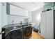 Well-equipped laundry room with Samsung washer and dryer, a utility sink, and storage cabinets at 22422 Stillwood Dr, Land O Lakes, FL 34639