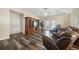 Spacious living room with a ceiling fan, wood flooring, a large built-in entertainment center and access to the pool at 22422 Stillwood Dr, Land O Lakes, FL 34639