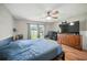 Spacious bedroom featuring wood floors, a ceiling fan, and ample natural light at 22422 Stillwood Dr, Land O Lakes, FL 34639