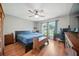 Comfortable bedroom with hardwood floors, ceiling fan, and a bright window view at 22422 Stillwood Dr, Land O Lakes, FL 34639