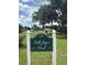 Lake Joyce Park entrance sign on a sunny day with a lake view and shady trees at 22422 Stillwood Dr, Land O Lakes, FL 34639