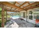 Outdoor patio with a sturdy overhead structure and view of the swimming pool and backyard at 22422 Stillwood Dr, Land O Lakes, FL 34639