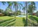 A backyard oasis featuring a private pool surrounded by lush landscaping and a screened-in patio at 22422 Stillwood Dr, Land O Lakes, FL 34639