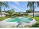 Beautiful backyard with a private pool, lush landscaping, and a covered patio area at 22422 Stillwood Dr, Land O Lakes, FL 34639