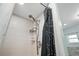 Clean shower with updated showerhead, a shower caddy, and modern fixtures at 22422 Stillwood Dr, Land O Lakes, FL 34639