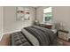 Comfortable bedroom with soft gray tones, stylish decor and a window view creating a soothing and relaxing atmosphere at 2812 Windcrest Oaks Ct, Valrico, FL 33594