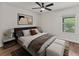 Well-lit bedroom featuring a stylish ceiling fan, modern decor and large windows providing comfort and a peaceful ambiance at 2812 Windcrest Oaks Ct, Valrico, FL 33594
