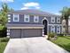 Stunning two-story home featuring a three-car garage and well-maintained landscaping at 2812 Windcrest Oaks Ct, Valrico, FL 33594