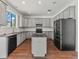 Spacious kitchen featuring modern appliances, gray cabinetry, dark countertops and a functional island at 2812 Windcrest Oaks Ct, Valrico, FL 33594