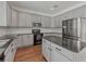 Well-equipped kitchen boasts stainless steel appliances, gray cabinetry, and a center island with dark countertops at 2812 Windcrest Oaks Ct, Valrico, FL 33594