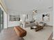Open living room with ample seating, ceiling fan, and access to the kitchen through a columned opening at 2812 Windcrest Oaks Ct, Valrico, FL 33594
