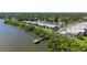 Breathtaking waterfront living featuring a community dock and mature trees throughout the community at 2980 Haines Bayshore Rd # 105, Clearwater, FL 33760