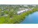 Waterfront condos featuring lush green landscaping, tennis courts, and serene water views at 2980 Haines Bayshore Rd # 105, Clearwater, FL 33760