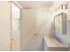 Clean bathroom featuring marble counters, a vanity, and accessible view into the other washroom at 2980 Haines Bayshore Rd # 105, Clearwater, FL 33760