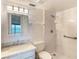 Bright bathroom featuring a marble countertop vanity and a walk-in shower with safety bars at 2980 Haines Bayshore Rd # 105, Clearwater, FL 33760