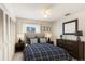 Comfortable bedroom featuring a ceiling fan, coordinated furnishings, and natural light at 2980 Haines Bayshore Rd # 105, Clearwater, FL 33760