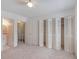 Bedroom with ensuite bathroom, closet, and carpet at 2980 Haines Bayshore Rd # 105, Clearwater, FL 33760