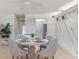 Dining area featuring a table with four chairs, tile floors and view of the kitchen at 2980 Haines Bayshore Rd # 105, Clearwater, FL 33760