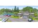 Attractive clubhouse exterior, showing a tennis court, landscaping, and convenient parking at 2980 Haines Bayshore Rd # 105, Clearwater, FL 33760
