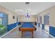 Well-lit game room featuring a pool table, blue accents, and bright windows at 2980 Haines Bayshore Rd # 105, Clearwater, FL 33760