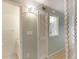 Hallway is light and airy, featuring a staircase, storage closet, and access to a bathroom at 2980 Haines Bayshore Rd # 105, Clearwater, FL 33760