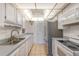 The kitchen includes white cabinetry, grey counters, and modern appliances at 2980 Haines Bayshore Rd # 105, Clearwater, FL 33760