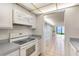 A kitchen view shows a kitchen looking into the living room and water view at 2980 Haines Bayshore Rd # 105, Clearwater, FL 33760