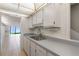 A kitchen view shows a kitchen looking into the living room and water view at 2980 Haines Bayshore Rd # 105, Clearwater, FL 33760