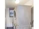 A laundry room features a stacked washer and dryer, maximizing space at 2980 Haines Bayshore Rd # 105, Clearwater, FL 33760
